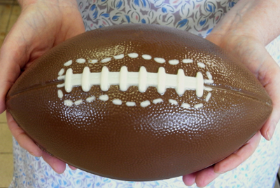 a picture of a milk chocolate football boot decorated with white and dark chocolate